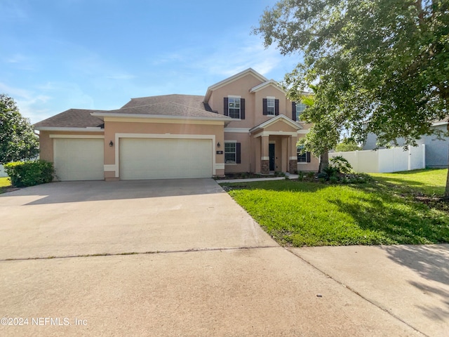 view of front of home featuring a garage and a front yard