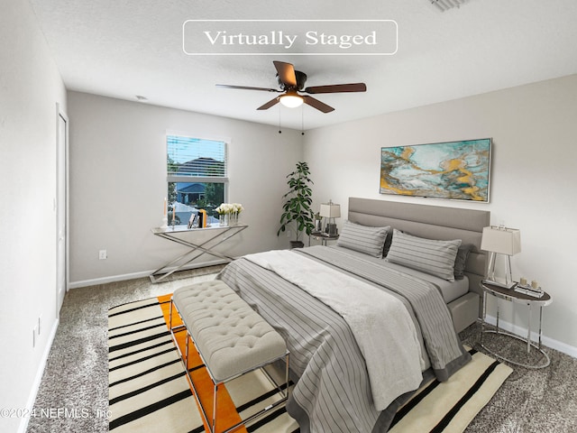 bedroom featuring ceiling fan and carpet