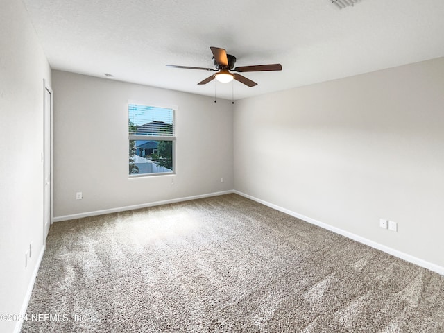 carpeted spare room with ceiling fan