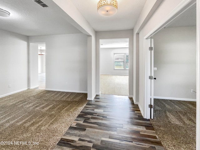 foyer with dark hardwood / wood-style flooring and a textured ceiling