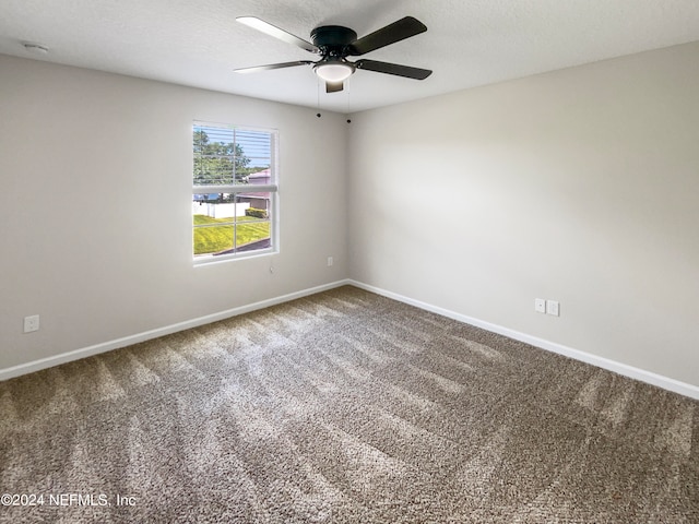 empty room featuring ceiling fan and carpet floors