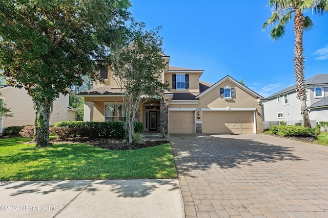 view of front of home with a garage and a front lawn