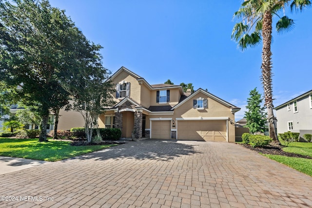 front of property with a garage and a front lawn