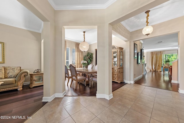 entryway featuring tile floors and ornamental molding