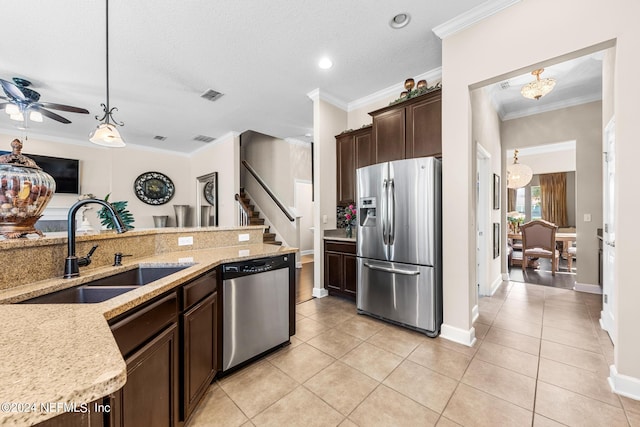 kitchen with hanging light fixtures, ornamental molding, dark brown cabinetry, and appliances with stainless steel finishes