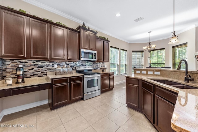 kitchen with tasteful backsplash, stainless steel appliances, light tile floors, hanging light fixtures, and sink