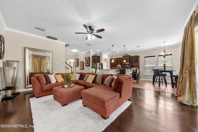 living room featuring a textured ceiling, hardwood / wood-style flooring, ceiling fan with notable chandelier, and crown molding