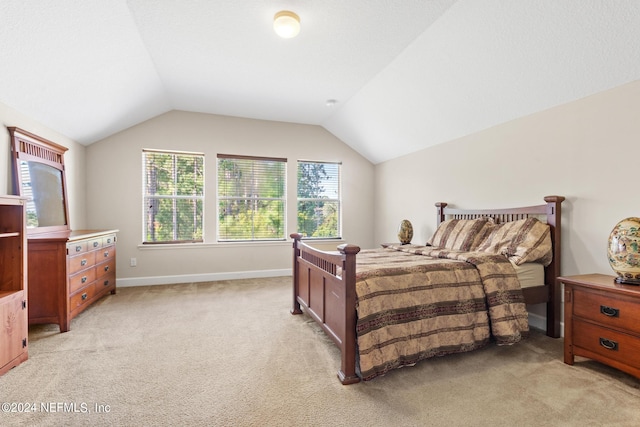 bedroom featuring light carpet and lofted ceiling