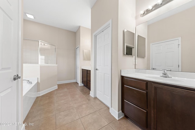 bathroom featuring a tub, tile flooring, and oversized vanity