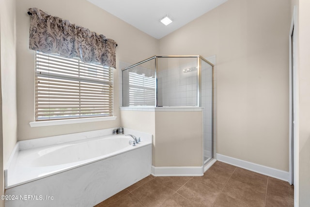 bathroom with shower with separate bathtub and tile floors