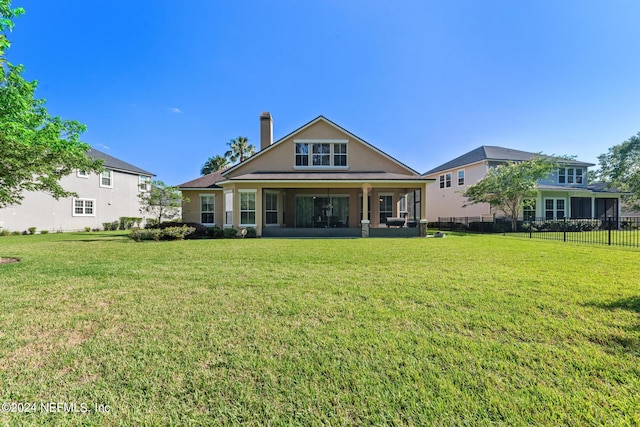 back of property featuring a lawn