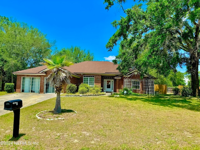 single story home featuring a front lawn and a garage