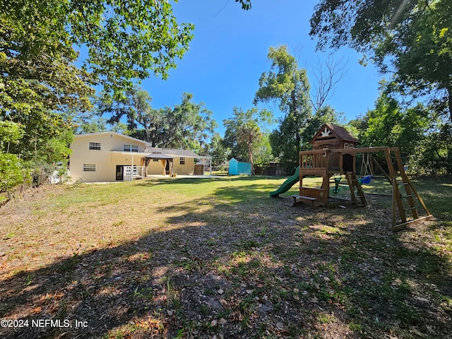 view of yard featuring a playground and a storage shed