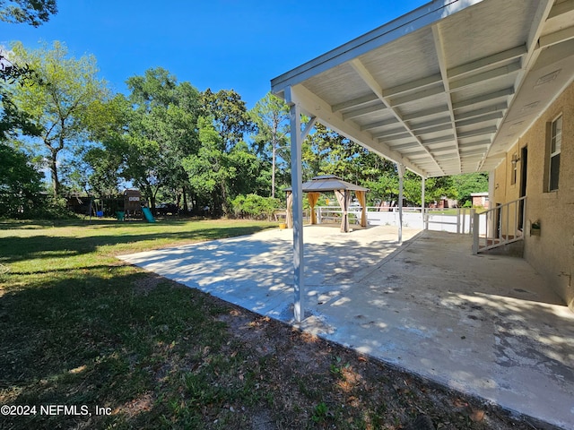 view of patio with a gazebo and a playground