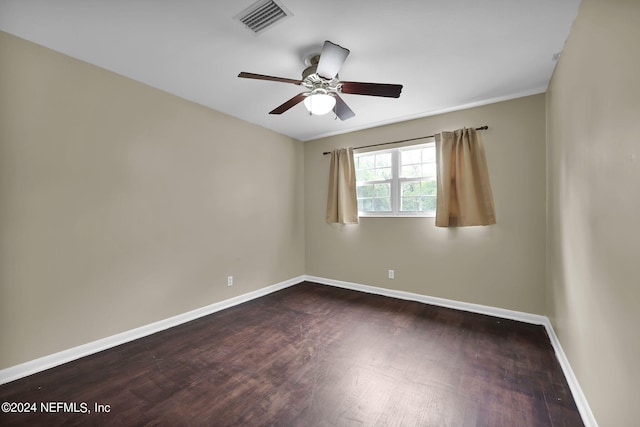 spare room with dark hardwood / wood-style flooring