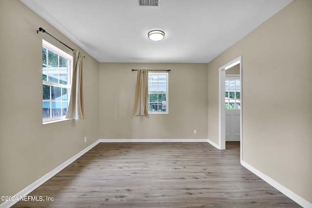 unfurnished room with hardwood / wood-style floors