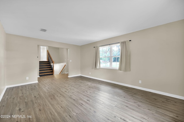 empty room with hardwood / wood-style flooring