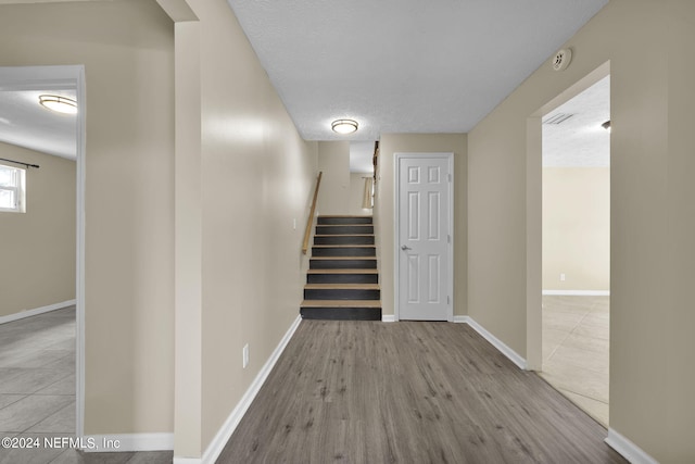 hall with light hardwood / wood-style flooring