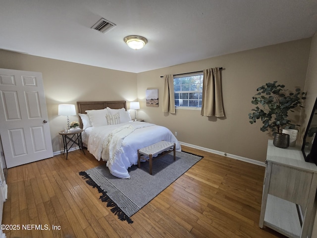 bedroom with hardwood / wood-style floors