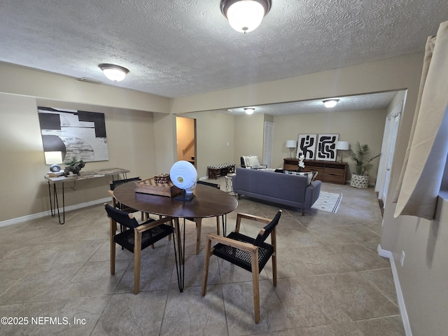 dining space with a textured ceiling