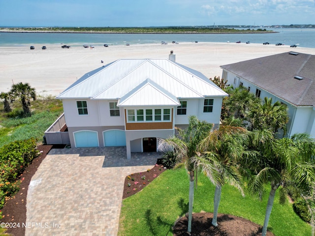 drone / aerial view with a water view and a view of the beach