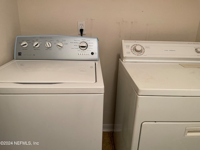 washroom with washing machine and clothes dryer