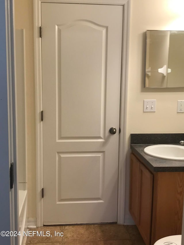 bathroom with tile patterned flooring and vanity