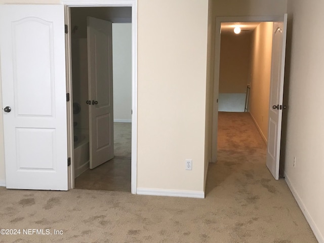 unfurnished bedroom with carpet flooring and baseboards