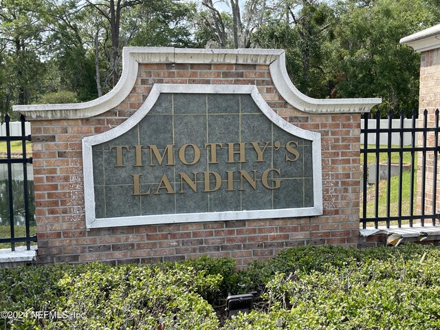 community / neighborhood sign with fence