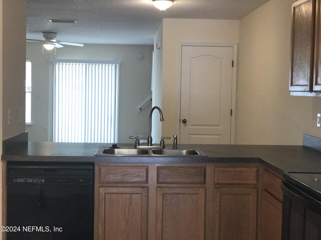 kitchen featuring dark countertops, ceiling fan, a textured ceiling, black appliances, and a sink