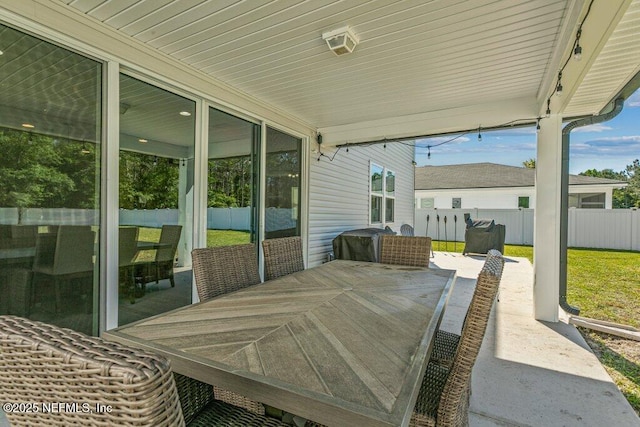 view of patio / terrace with outdoor dining area and fence