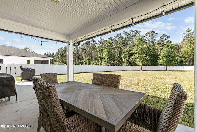 view of patio featuring grilling area, a fenced backyard, and outdoor dining space
