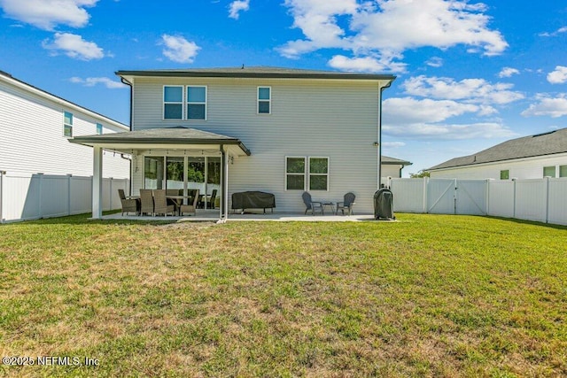 rear view of property with a fenced backyard, a gate, and a patio