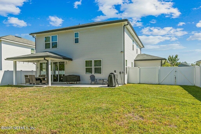 rear view of house featuring a gate, a yard, a patio area, and a fenced backyard
