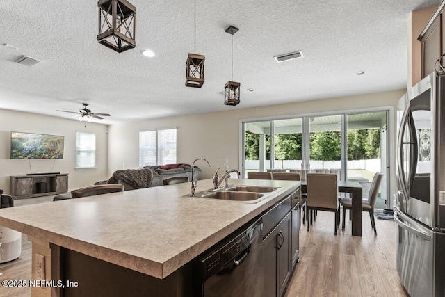 kitchen featuring a sink, a textured ceiling, smart refrigerator, visible vents, and dishwasher