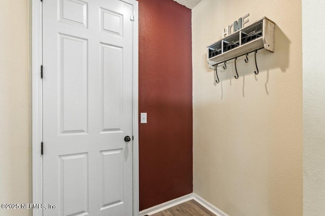 mudroom with wood finished floors and baseboards