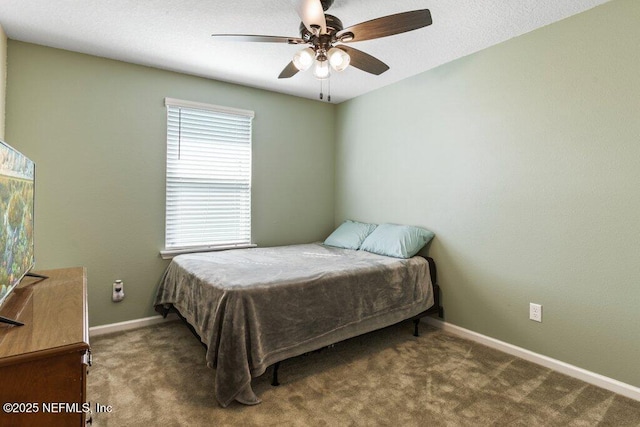 carpeted bedroom featuring a ceiling fan and baseboards