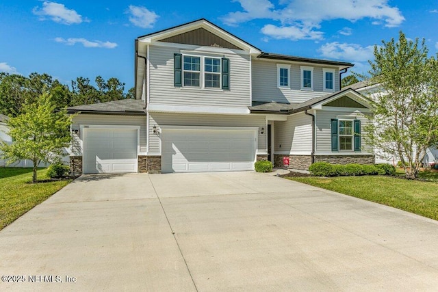 craftsman inspired home with a garage, stone siding, a front lawn, and concrete driveway