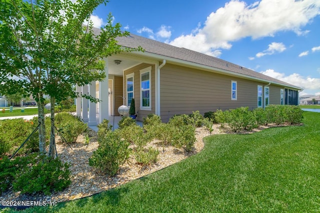 view of side of property featuring a yard