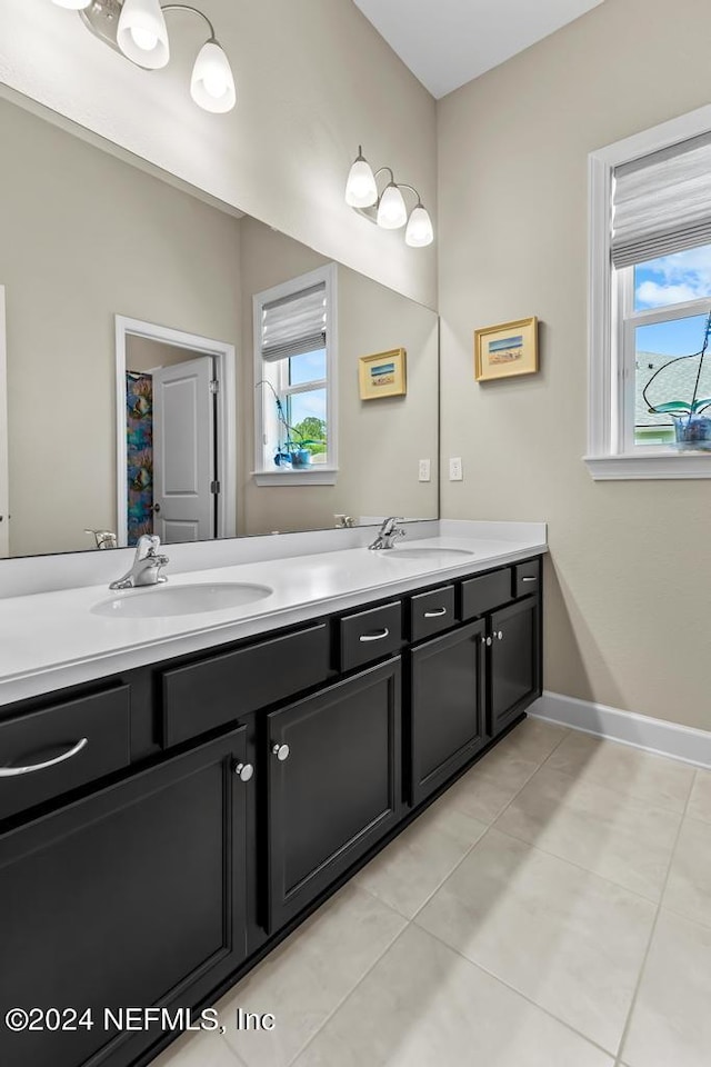 bathroom featuring double vanity and tile flooring