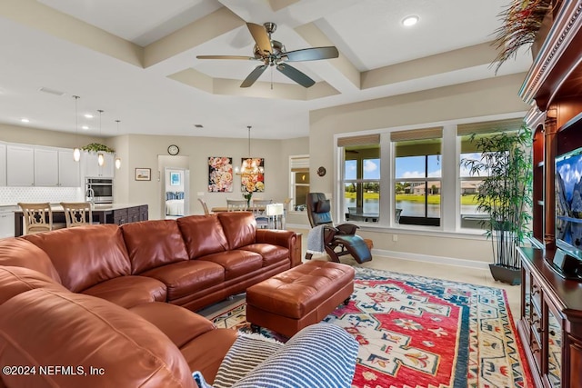 living room featuring coffered ceiling and ceiling fan with notable chandelier