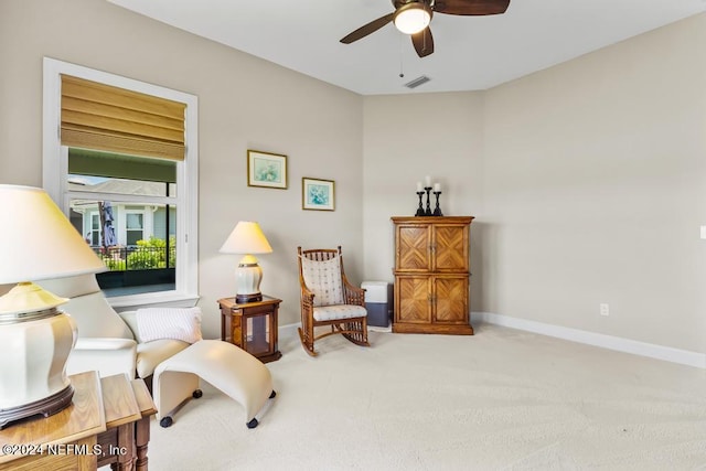 sitting room featuring ceiling fan and carpet floors