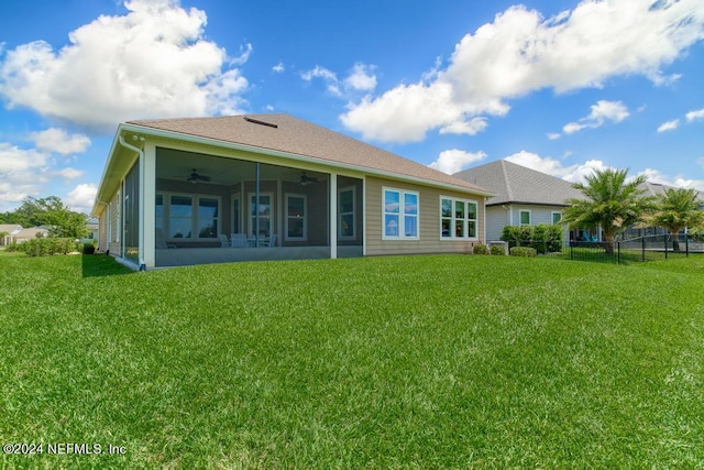 back of property featuring a trampoline, ceiling fan, and a yard