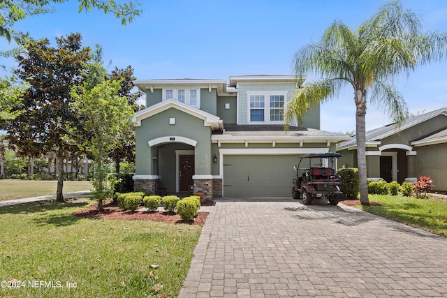 view of front of home with a garage and a front lawn