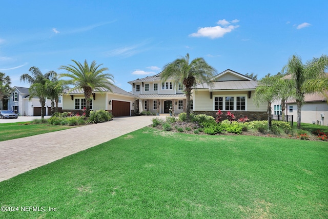 view of front facade with a garage and a front lawn