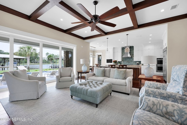 living room featuring coffered ceiling, ceiling fan, and beam ceiling