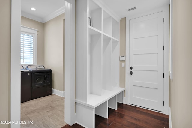 mudroom featuring hardwood / wood-style flooring, ornamental molding, and washing machine and clothes dryer