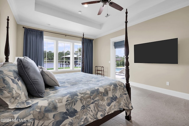 carpeted bedroom featuring crown molding, a raised ceiling, and ceiling fan