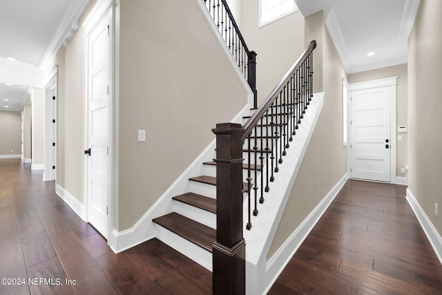 stairway featuring hardwood / wood-style floors and ornamental molding