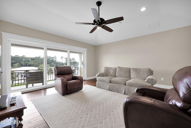 living room with wood-type flooring and ceiling fan